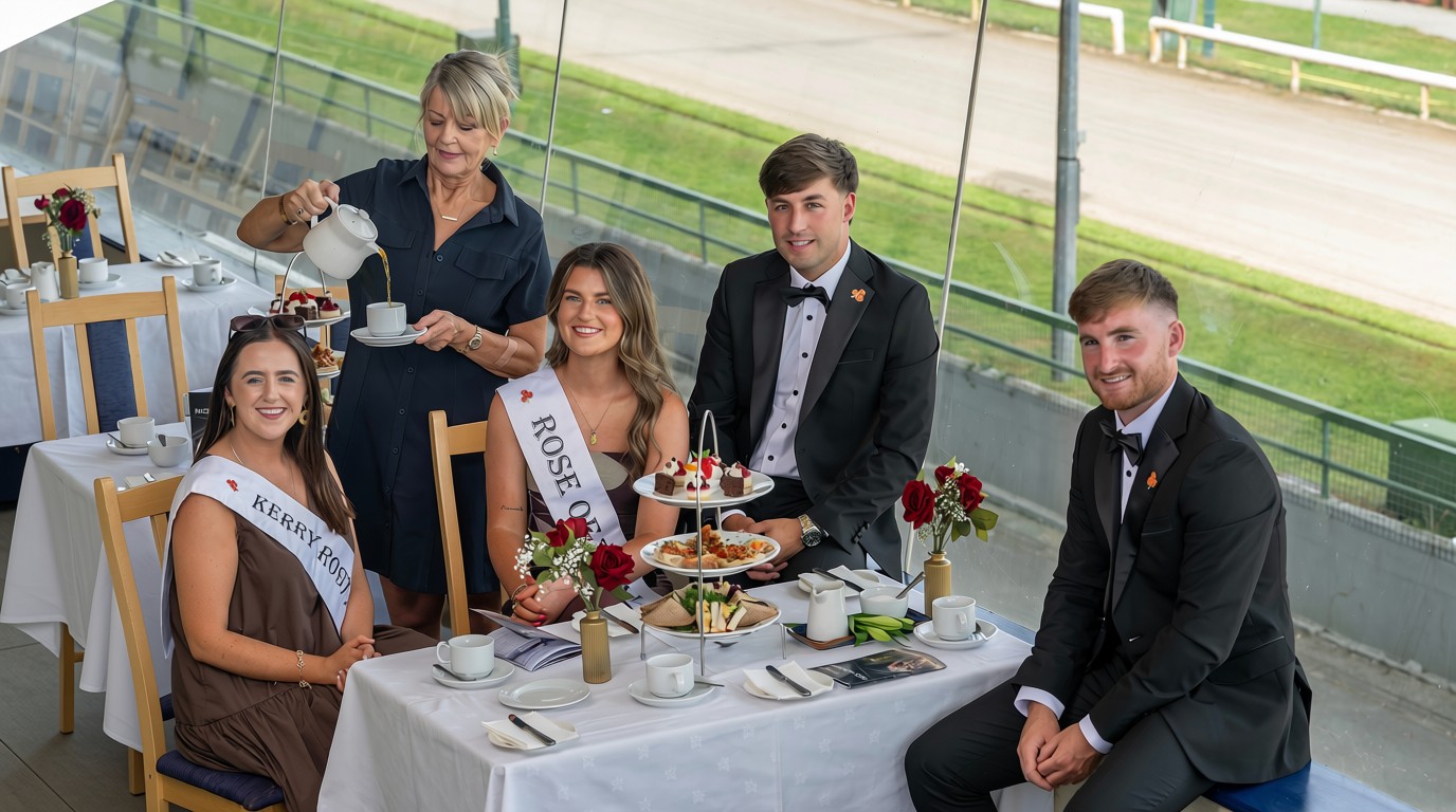 Picture shows 2 woman and 2 men dressed well sitting at a table in the Kingdom greyhound Stadium with an afternoon tea setting 